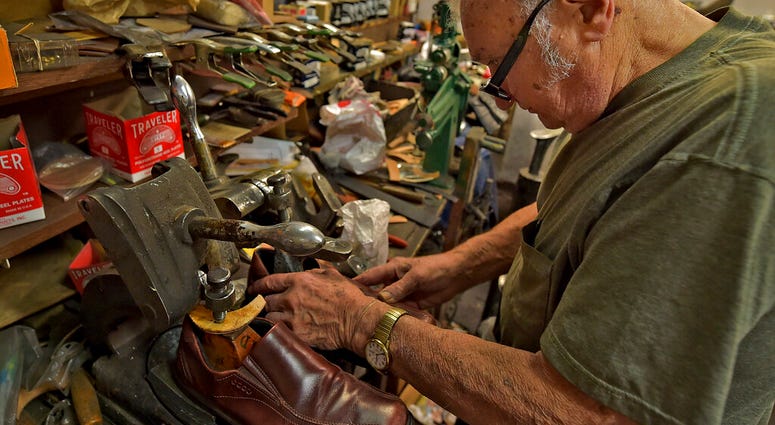 Tony Bonczewski repairs a heel on a customer's shoe at his cobbler shop in Wilkes-Barre, Pa.