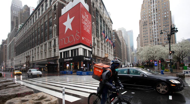 A cyclist passes Macy's in Herald Square, Monday, March 23, 2020, in New York. Macy's stores nationwide are closed due to the coronavirus.
