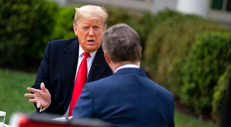 President Donald Trump talks with host Bill Hemmer during a FOX News Channel virtual town hall with members of the coronavirus task force, in the Rose Garden at the White House, Tuesday, March 24, 2020, in Washington.