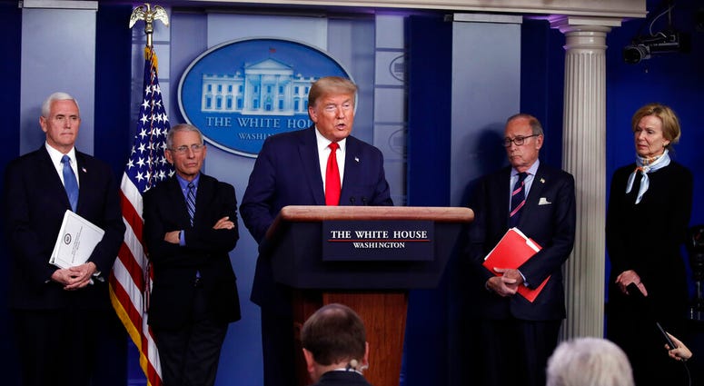 President Donald Trump speaks about the coronavirus in the James Brady Briefing Room, Tuesday, March 24, 2020, in Washington, as Vice President Mike Pence, Dr. Anthony Fauci, director of the National Institute of Allergy and Infectious Diseases, Larry Kud