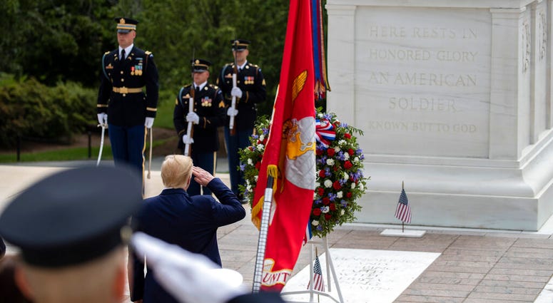 President Donald Trump salutes before placing a wreath at the Tomb of the Unknown Soldier in Arlington National Cemetery, in honor of Memorial Day, Monday, May 25, 2020, in Arlington, Va. (AP Photo/Alex Brandon)