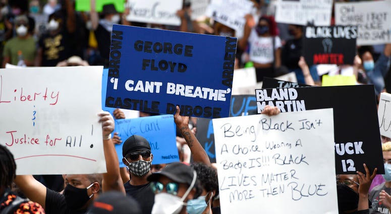 Demonstrators protest in Centennial Olympic Park, Friday, May 29, 2020 in Atlanta. Protests were organized in cities around the United States following the death of George Floyd during an arrest in Minneapolis. (AP Photo/Mike Stewart)
