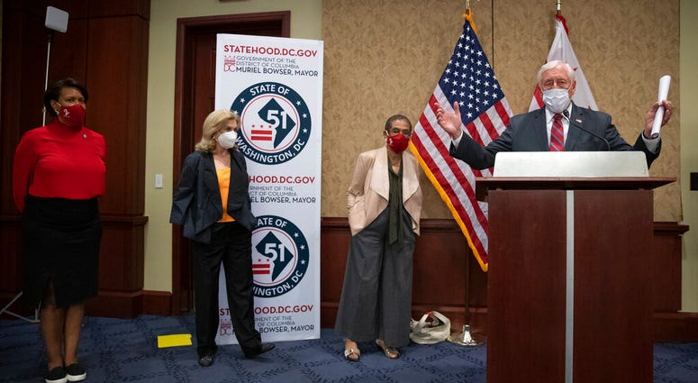 From left, District of Columbia Mayor Muriel Bowser, Rep. Carolyn Maloney, D-N.Y., Delegate Eleanor Holmes Norton, D-D.C., and House Majority Leader Steny Hoyer of Md., practice social distancing as they participate in a news conference on Capitol Hill in