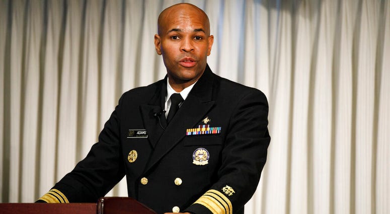 Surgeon General Jerome Adams speaks at the National Press Club about a campaign to raise awareness on the risks of veterans suicide, Tuesday, July 7, 2020, in Washington. (AP Photo/Jacquelyn Martin)