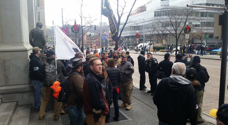 crowd begins to gather for a gun rights rally downtown