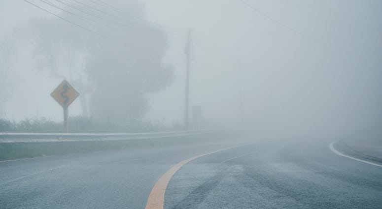 foggy rural asphalt highway perspective with white line, misty road, Road with traffic and heavy fog, bad weather driving - stock photo foggy rural asphalt highway perspective with white line, misty road, Road with traffic and heavy fog, bad weather driving - stock photo