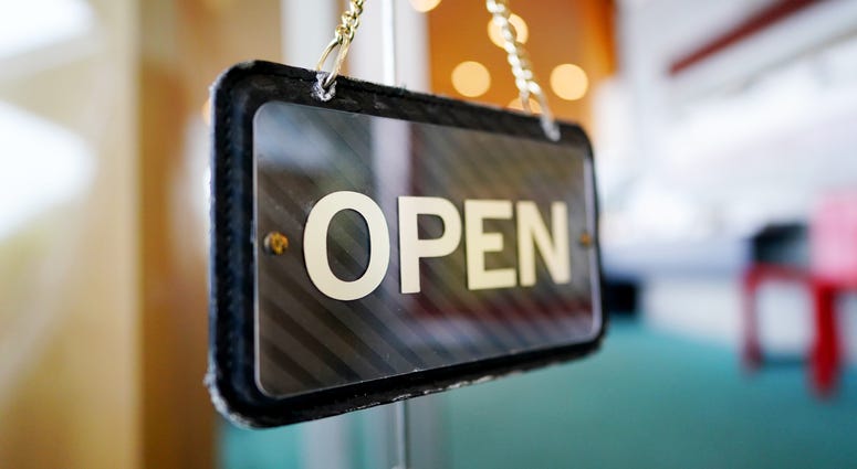 Open Sign Hangs in Business Window Open Sign Hangs in Business Window