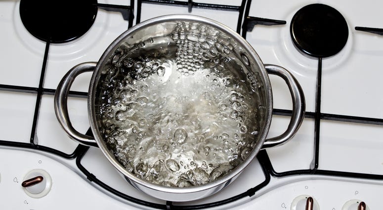 casserole with boiling water on the stove casserole with boiling water on the stove