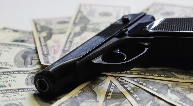 Pistol and money as sign of criminal activity Pistol and money as sign of criminal activity