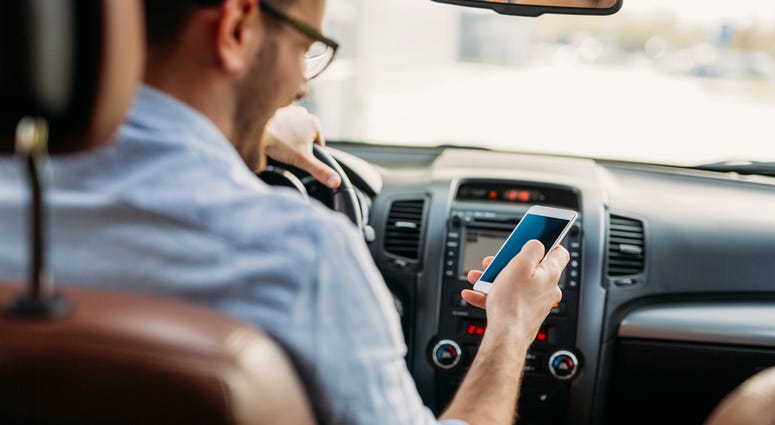 Man Driving while using cell phone
