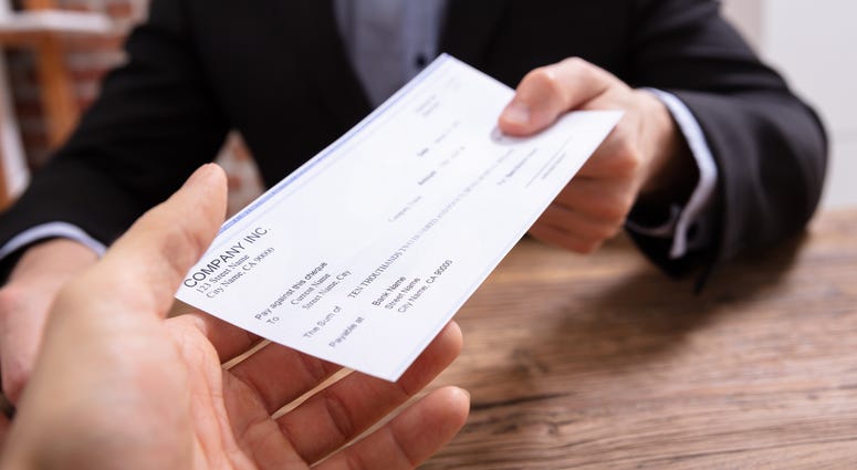 Man's Hands Giving Check To Other Person Man's Hands Giving Check To Other Person