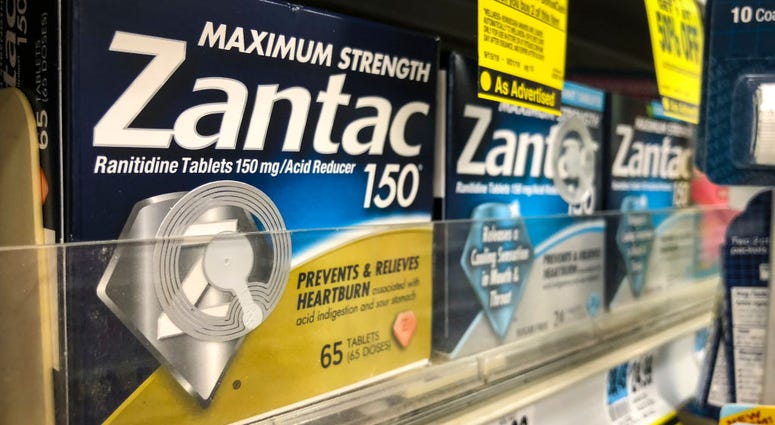 Packages of Zantac, a popular medication which decreases stomach acid production and prevents heartburn, sit on a shelf at a drugstore