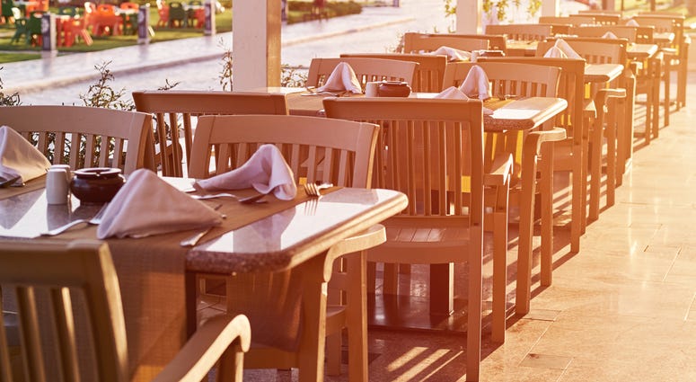 Empty terrace with a table and chairs outdoor in sunset Empty terrace with a table and chairs outdoor in sunset