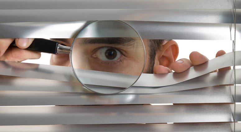 Peaking through window blinds Peaking through window blinds