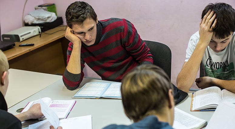 Teenagers working on homework Teenagers working on homework