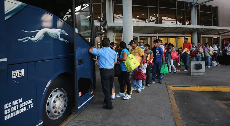 Central American travelers boarding a Greyhound bus Central American travelers boarding a Greyhound bus