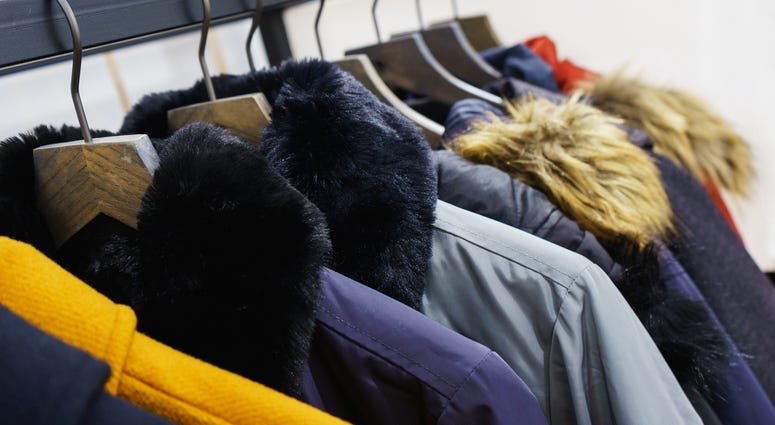Modern outerwear in a shop on a hanger. Jackets, parks and warm outerwear of different colors and denim for youth. Modern outerwear in a shop on a hanger. Jackets, parks and warm outerwear of different colors and denim for youth.