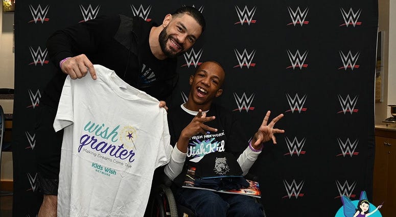 WWE superstar Roman Reigns snags a photo with his biggest fan, Markel Smith at the FedExForum in Memphis. WWE superstar Roman Reigns snags a photo with his biggest fan, Markel Smith at the FedExForum in Memphis.