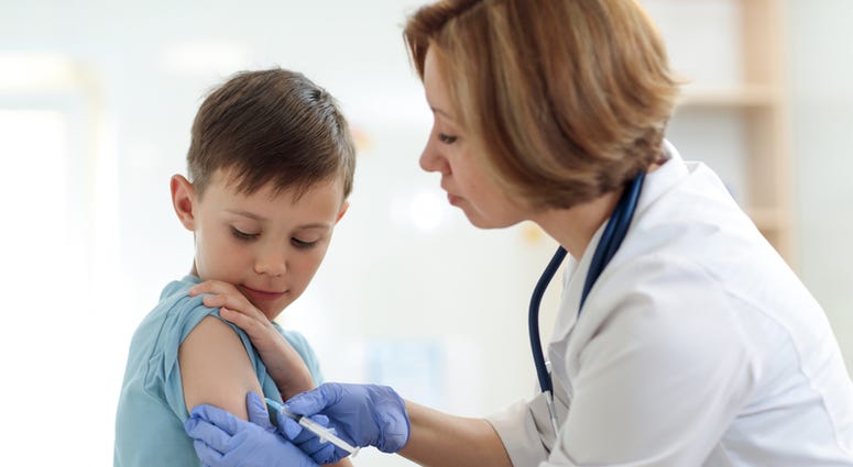 Doctor giving a child a shot