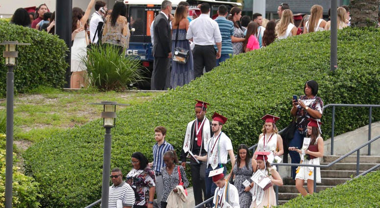 People leave a graduation ceremony for Marjory Stoneman Douglas seniors, Sunday, June 3, 2018, in Sunrise, Fla. DO NOT USE