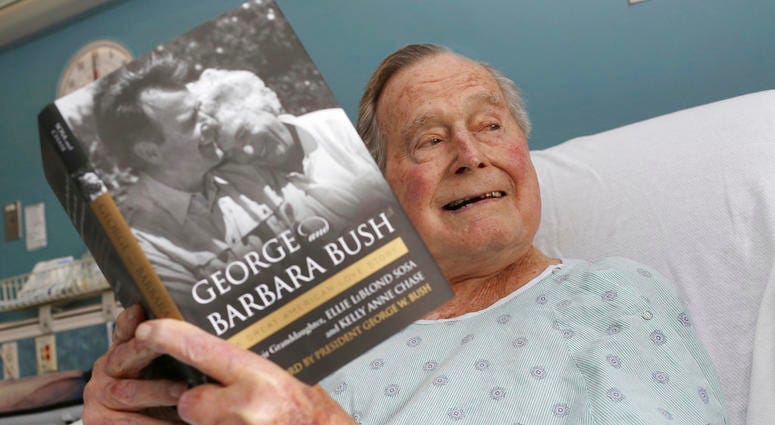 file photo provided by Office of George H. W. Bush shows a photo of former President George H.W. Bush that was tweeted on Friday, June 1, 2018, from his hospital bed while reading a book about himself and his late wife DO NOT USE