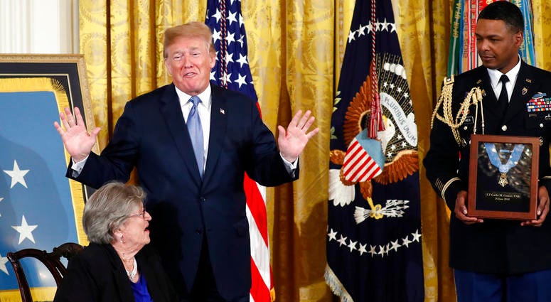 President Donald Trump speaks before he awards the Medal of Honor to 1st Lt. Garlin Conner as his widow Pauline Connor accepts the posthumous recognition, during a ceremony in the East Room DO NOT USE