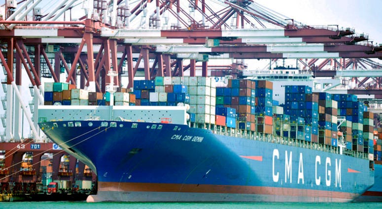 In this July 6, 2018, photo, a container ship is docked at a port in Qingdao in eastern China's Shandong Province. DO NOT USE