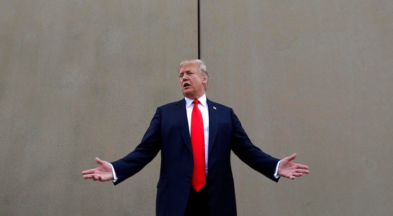 In this March 13, 2018, file photo, President Donald Trump speaks during a tour as he reviews border wall prototypes in San Diego. DO NOT USE