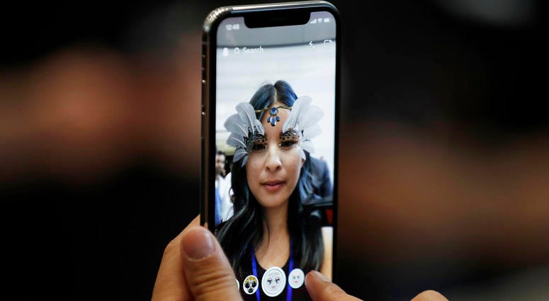 the new iPhone X is displayed in the showroom after the new product announcement in Cupertino, Calif. DO NOT USE