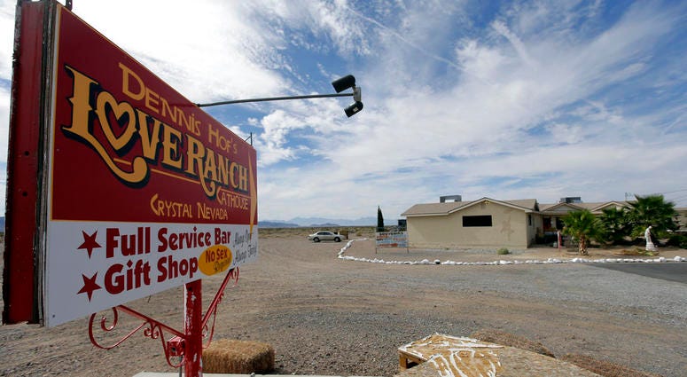 , file photo, a sign advertises Dennis Hof's Love Ranch brothel in Crystal, Nev. DO NOT USE