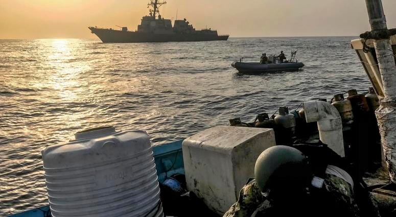 In this photo made available Thursday, Aug. 30, 2018, a team from the guided-missile destroyer USS Jason Dunham inspects a dhow while conducting maritime security operations. DO NOT USE