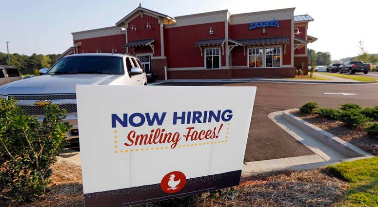 This July 25, 2018, photo shows a help wanted sign at a new Zaxby's restaurant in Madison, Miss. On Friday, Sept. 7, the Labor Department reports on job openings and labor turnover for August. DO NOT USE