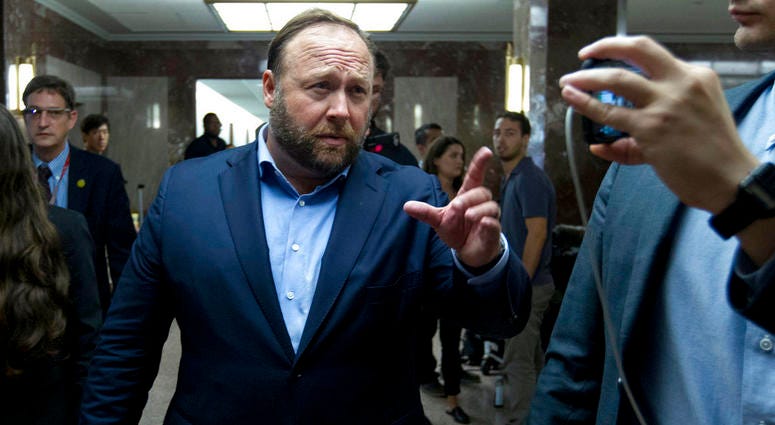 Alex Jones, the right-wing conspiracy theorist, walks the corridors of Capitol Hill after listening to Facebook COO Sheryl Sandberg and Twitter CEO Jack Dorsey testify before the Senate Intelligence Committee on 'Foreign Influence Operations DO NOT USE