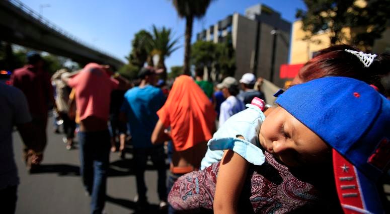 A sleeping Honduran girl is carried as a group of Central American migrants in a caravan trying to reach the U.S. border A sleeping Honduran girl is carried as a group of Central American migrants in a caravan trying to reach the U.S. border