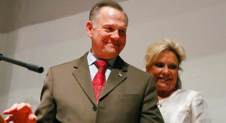 In this Tuesday, Dec. 12, 2017, file photo, Republican Senate candidate Roy Moore walks off the stage with wife Kayla Moore after he spoke to supporters after an election-night watch party