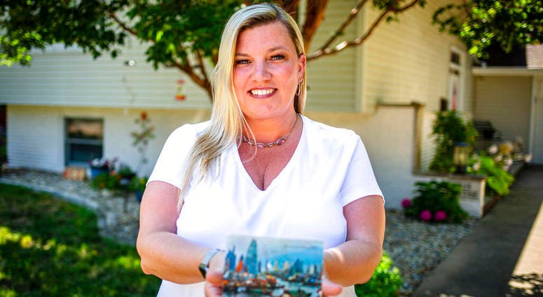 Kim Draper received a postcard at her home in Springfield on July 8, 2019 that was postmarked and sent from Hong Kong exactly 26 years ago on July 8, 1993 to a previous family that lived at her address. AP DO NOT USE
