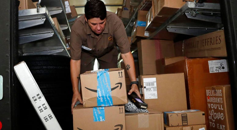 UPS employee Liz Perez unloads packages for delivery in Miami. AP DO NOT USE