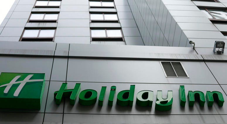In this file photo dated March 28, 2019, the sign for a Holiday Inn in New York. The fight to save the seas from plastic waste may mean the end for mini bottles of shampoo and other toiletries, after the owner of Holiday Inn and InterContinental Hotels an