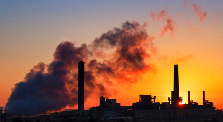 In this July 27, 2018, file photo, the Dave Johnson coal-fired power plant is silhouetted against the morning sun in Glenrock, Wyo.