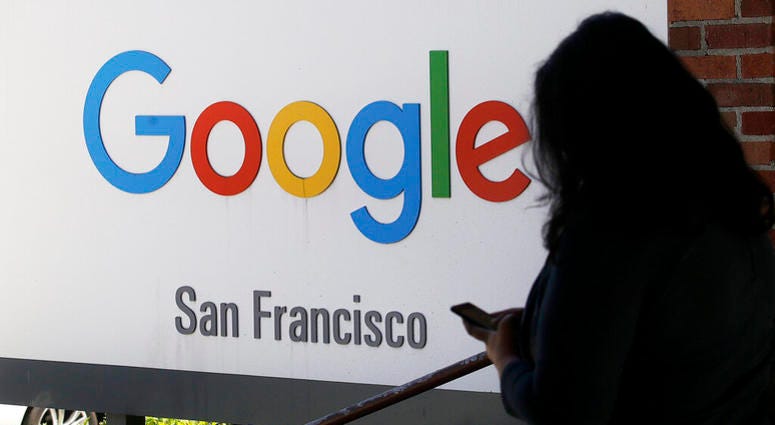 In this May 1, 2019, file photo, a person walks past a Google sign in San Francisco. AP DO NO TUSE