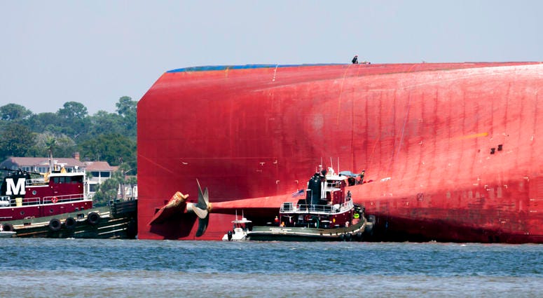 Rescuers work near the stern of the vessel Golden Ray as it lays on its side near the Moran tug boat Dorothy Moran, Monday, Sept. 9, 2019, in Jekyll Island, Ga. AP DO NOT USE