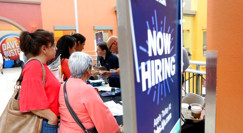 people wait in line to inquire about job openings with Marshalls during a job fair at Dolphin Mall in Miami. On Friday, Dec. 6, the U.S. government issues the November jobs report. people wait in line to inquire about job openings with Marshalls during a job fair at Dolphin Mall in Miami. On Friday, Dec. 6, the U.S. government issues the November jobs report.