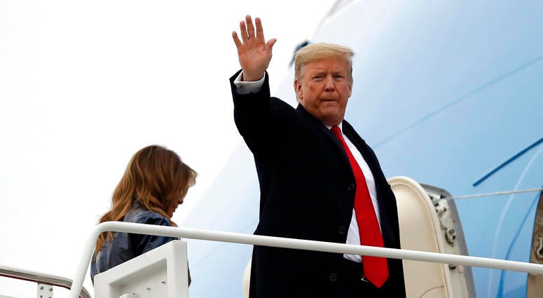 President Donald Trump boards Air Force One with first lady Melania Trump for a trip to New Orleans to attend the College Football Playoff National Championship game between LSU and Clemson, Monday, Jan. 13, 2020, at Andrews Air Force Base, Md.