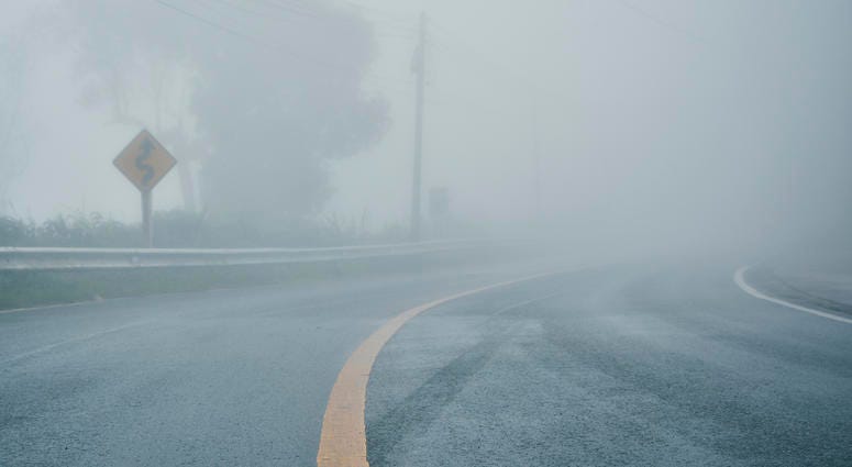 foggy rural asphalt highway perspective with white line, misty road, Road with traffic and heavy fog, bad weather driving - stock photo foggy rural asphalt highway perspective with white line, misty road, Road with traffic and heavy fog, bad weather driving - stock photo