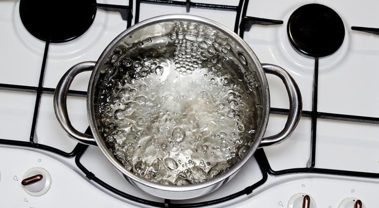 casserole with boiling water on the stove casserole with boiling water on the stove