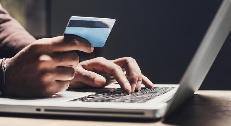 Man shopping online using laptop computer and credit card Man shopping online using laptop computer and credit card