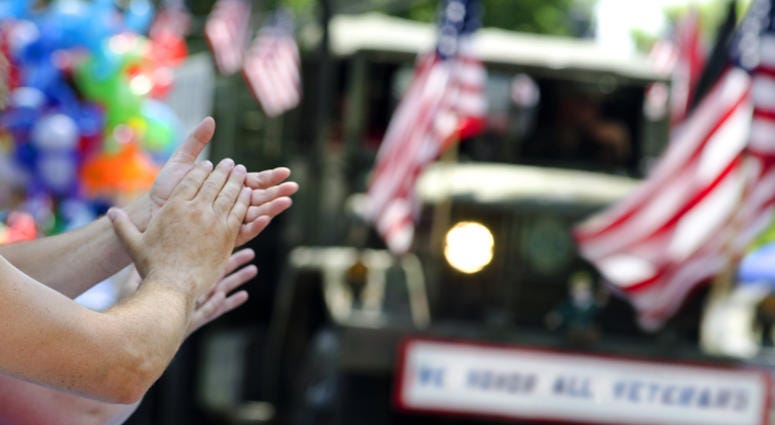 closeup of hands clapping at veterans parade closeup of hands clapping at veterans parade