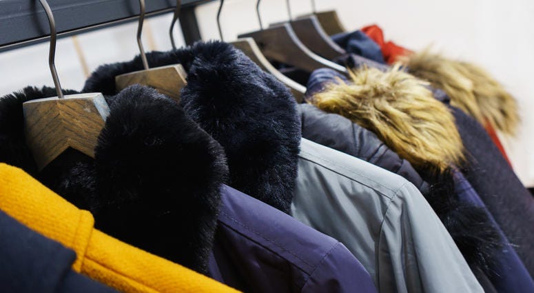 Modern outerwear in a shop on a hanger. Jackets, parks and warm outerwear of different colors and denim for youth. Modern outerwear in a shop on a hanger. Jackets, parks and warm outerwear of different colors and denim for youth.