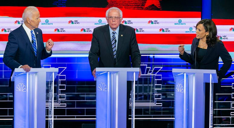 Sen. Kamala Harris (D-Calif.), right, speaks to former Vice President Joe Biden, left, as Sen. Bernie Sanders (I-Vt.) l Sen. Kamala Harris (D-Calif.), right, speaks to former Vice President Joe Biden, left, as Sen. Bernie Sanders (I-Vt.) l