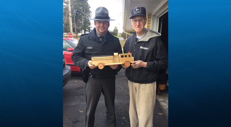 Ed Higinbotham donating his wooden toys to State Police